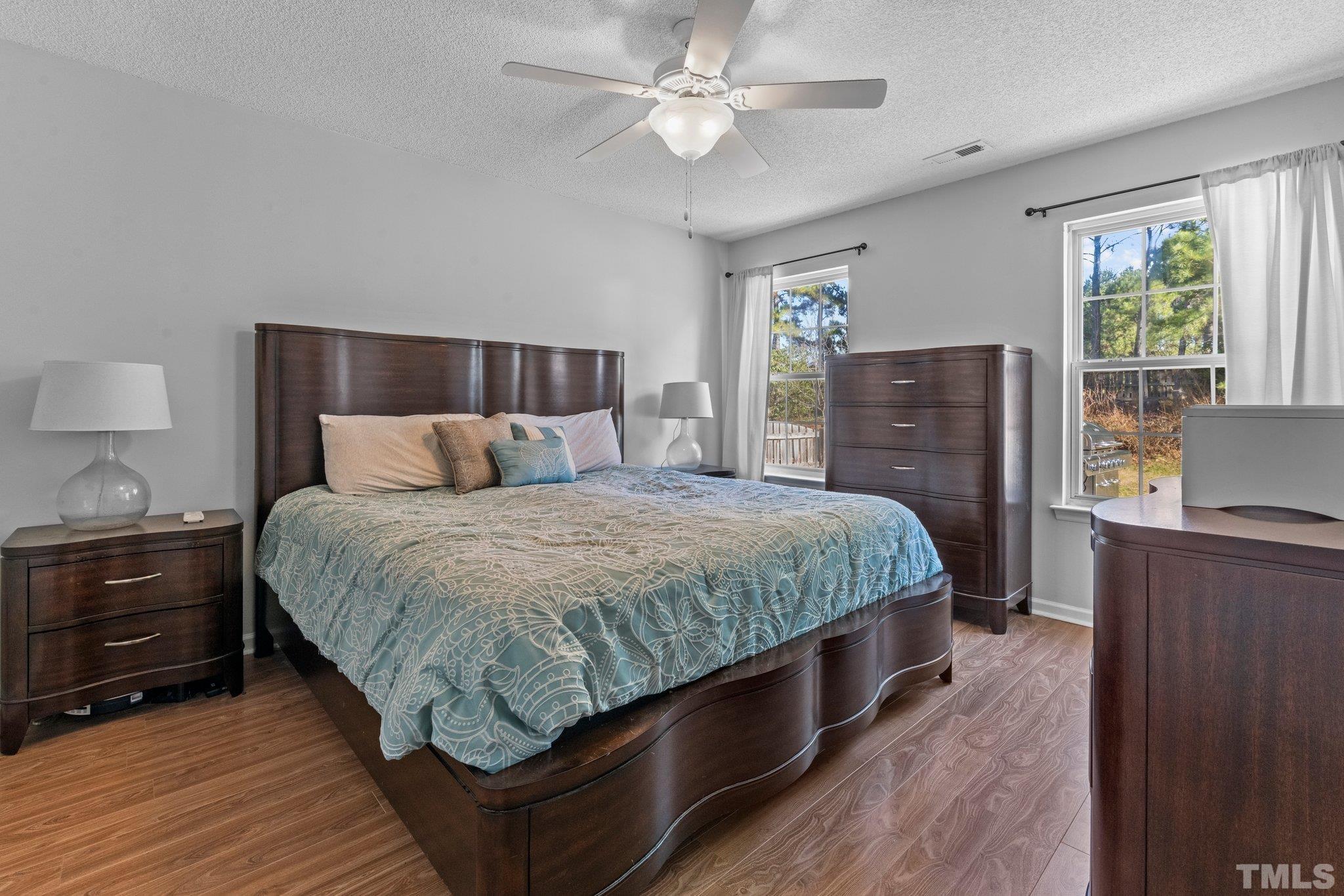 506 Ashford Lane Durham, NC 27713 - Photo 10 of 27 a bedroom with a bed dresser and a window