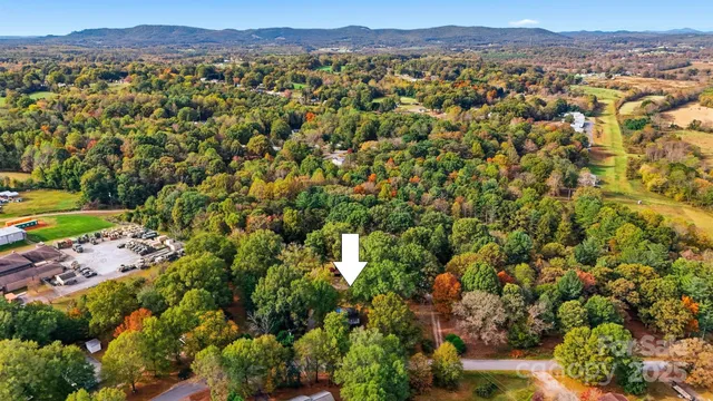 a yellow house with a tree in front of it