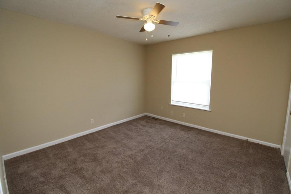 1088 Pembroke Oak Grove Road, Unit 21 Oak Grove, KY 42262 - Photo 5 of 6 an empty room with a window and a fan
