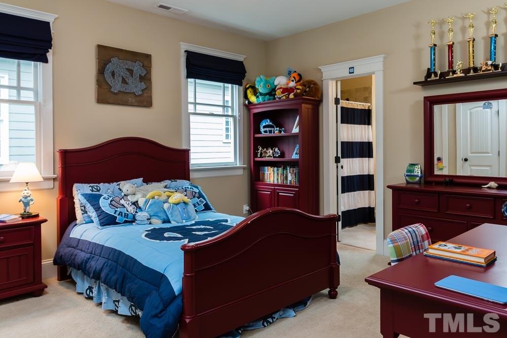 3048 Farrior Road Raleigh, NC 27607 - Photo 11 of 25 a bedroom with furniture and a book shelf