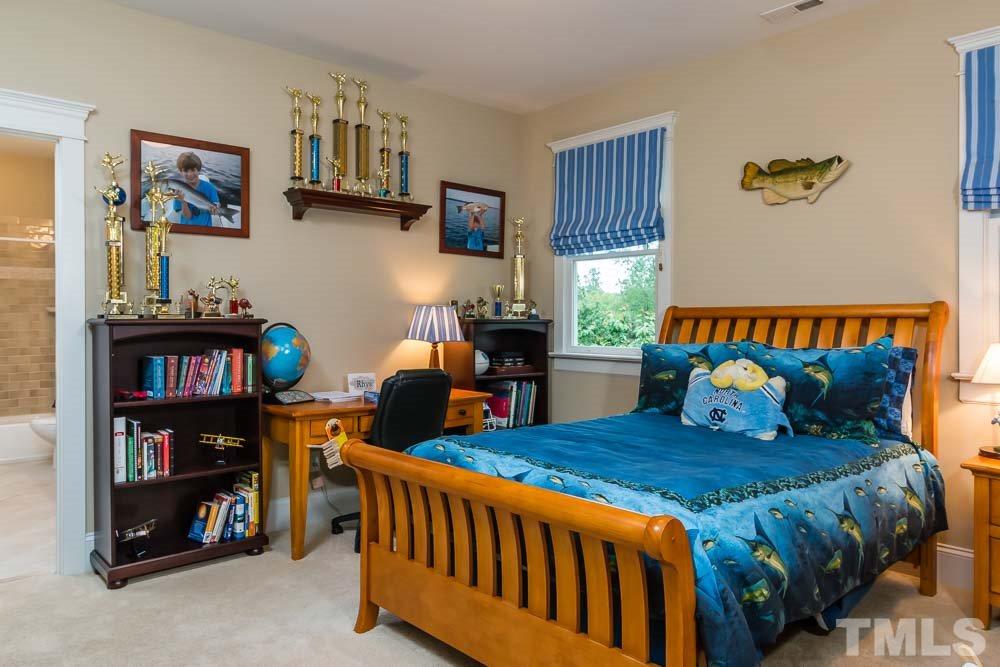 3048 Farrior Road Raleigh, NC 27607 - Photo 12 of 25 a bedroom with furniture and a book shelf