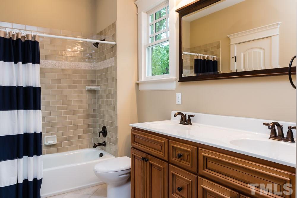 3048 Farrior Road Raleigh, NC 27607 - Photo 13 of 25 a bathroom with a sink a toilet and shower