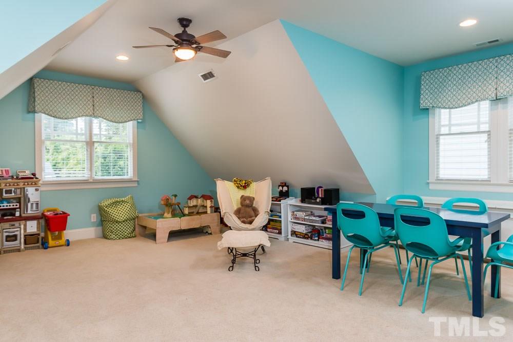 3048 Farrior Road Raleigh, NC 27607 - Photo 15 of 25 a living room with furniture and a chandelier