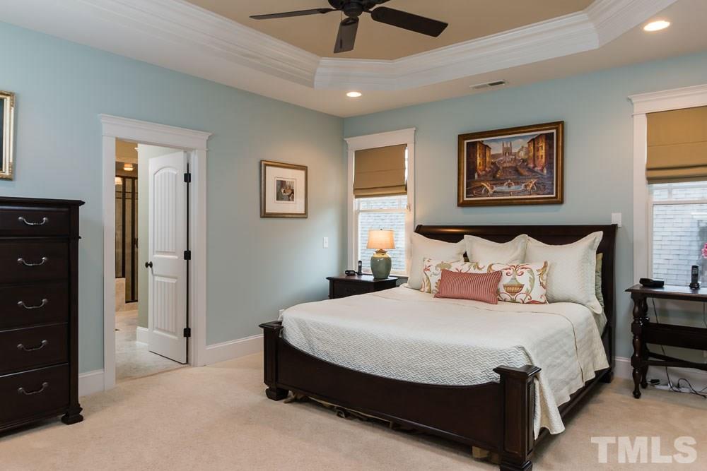3048 Farrior Road Raleigh, NC 27607 - Photo 17 of 25 a spacious bedroom with a bed and a chandelier
