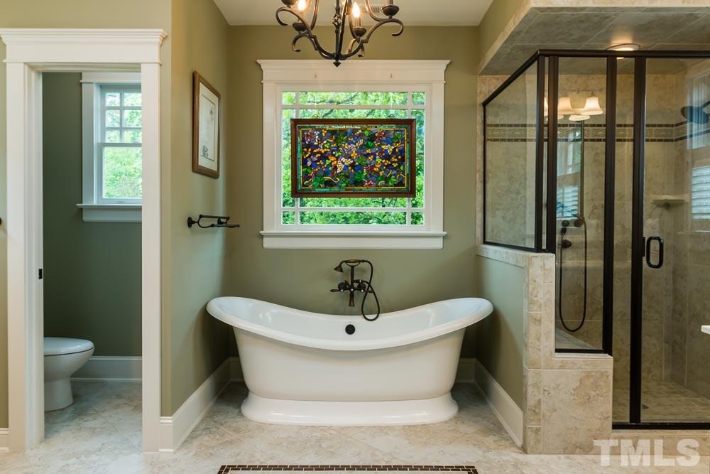 3048 Farrior Road Raleigh, NC 27607 - Photo 18 of 25 a bathroom with a sink and a large mirror