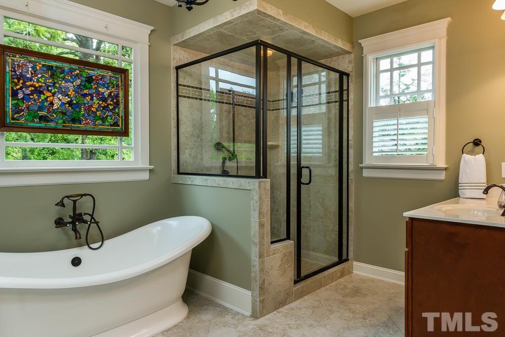 3048 Farrior Road Raleigh, NC 27607 - Photo 19 of 25 a bathroom with a sink and mirror with bathtub