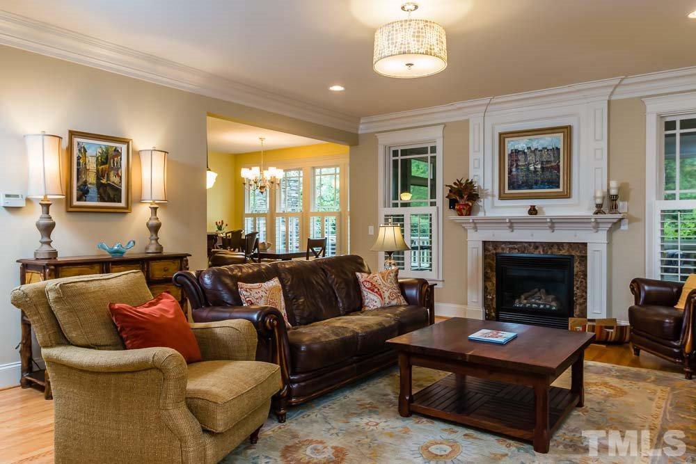 3048 Farrior Road Raleigh, NC 27607 - Photo 6 of 25 a living room with furniture a large window and a fireplace