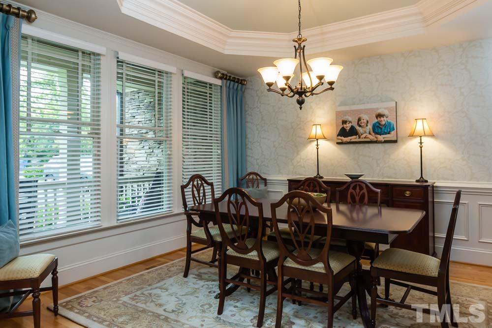 3048 Farrior Road Raleigh, NC 27607 - Photo 7 of 25 a view of a dining room with furniture a chandelier and wooden floor