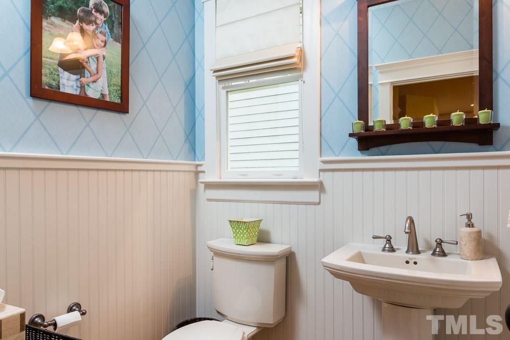 3048 Farrior Road Raleigh, NC 27607 - Photo 8 of 25 a bathroom with a sink a mirror and a toilet