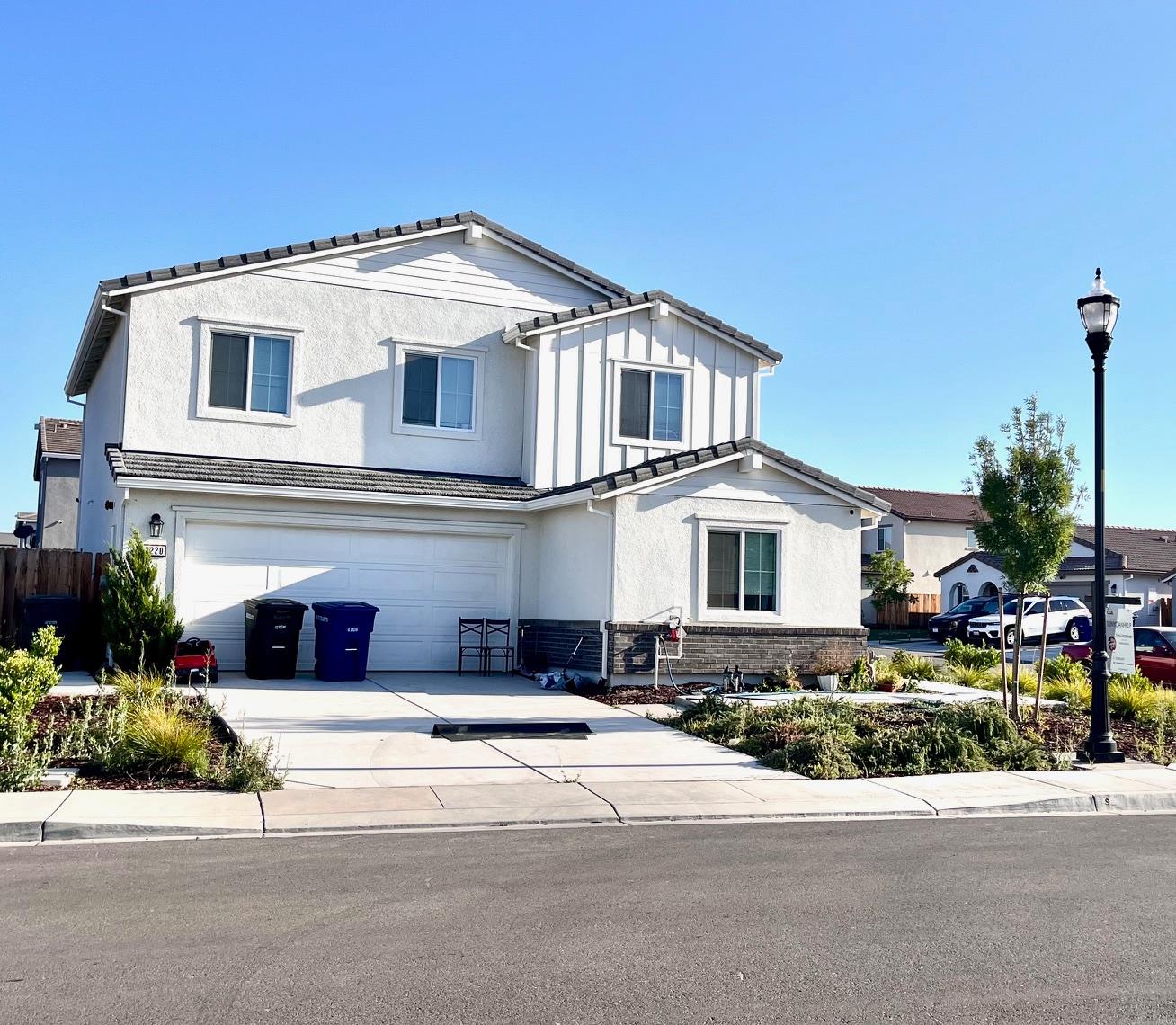a front view of a house with a garden