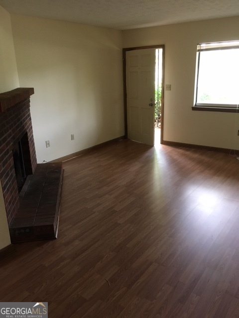 317 Epps Bridge Road Athens, GA 30606 - Photo 3 of 5 a view of an empty room with wooden floor and a window