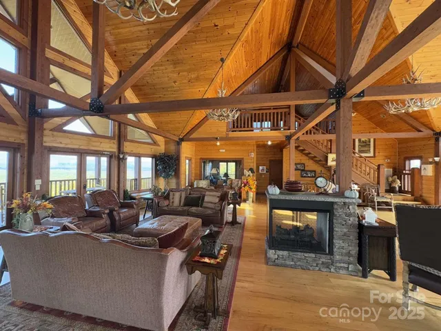a roof deck with table and chairs and potted plants