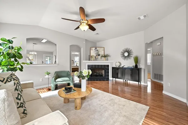a living room with furniture and a wooden floor