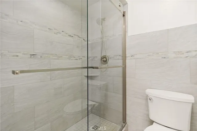 an aerial view of a city with swimming pool lake and buildings in the background