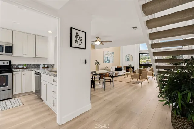 a kitchen with stainless steel appliances granite countertop a stove a refrigerator and a microwave