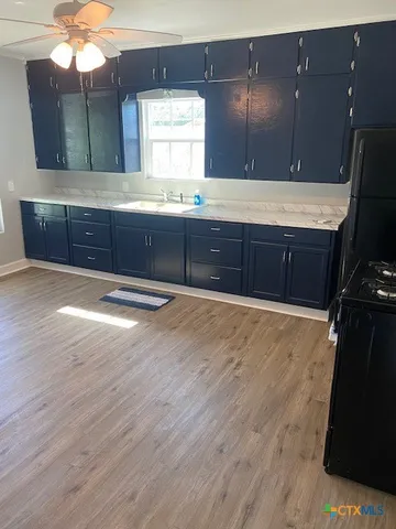 a kitchen with wooden cabinets and a sink
