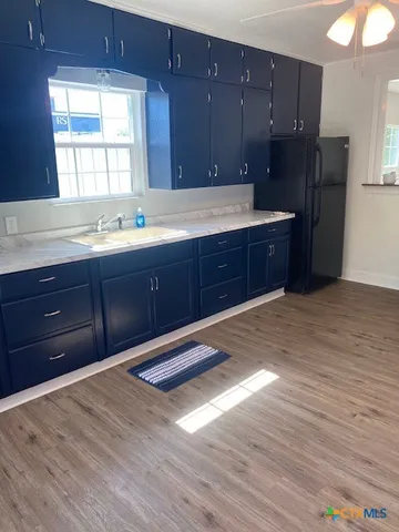 a view of room with window and wooden floor