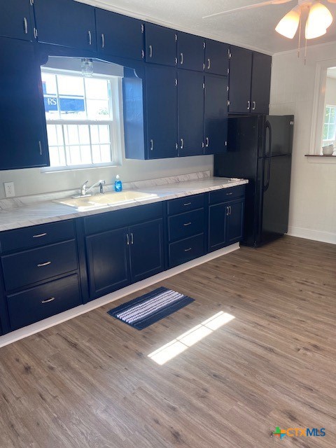 2405 Lone Tree Road Victoria, TX 77901 - Photo 5 of 13 a kitchen with wooden cabinets and a sink