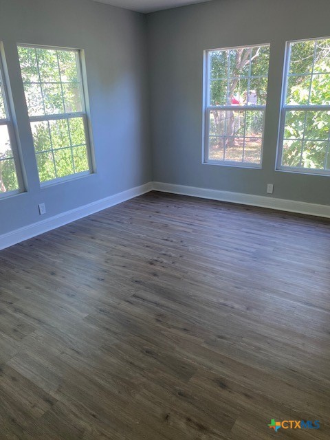 2405 Lone Tree Road Victoria, TX 77901 - Photo 8 of 13 an empty room with wooden floor and windows