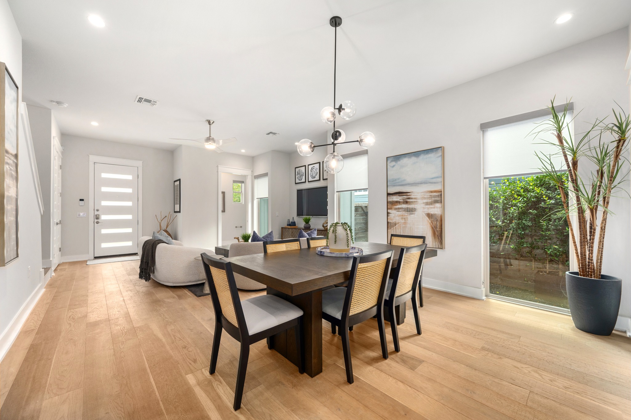 1409 Alegria Road, Unit A Austin, TX 78757 - Photo 6 of 24 Blonde hardwood floors flow through this light-filled dining area, seamlessly connecting to a welcoming living space.