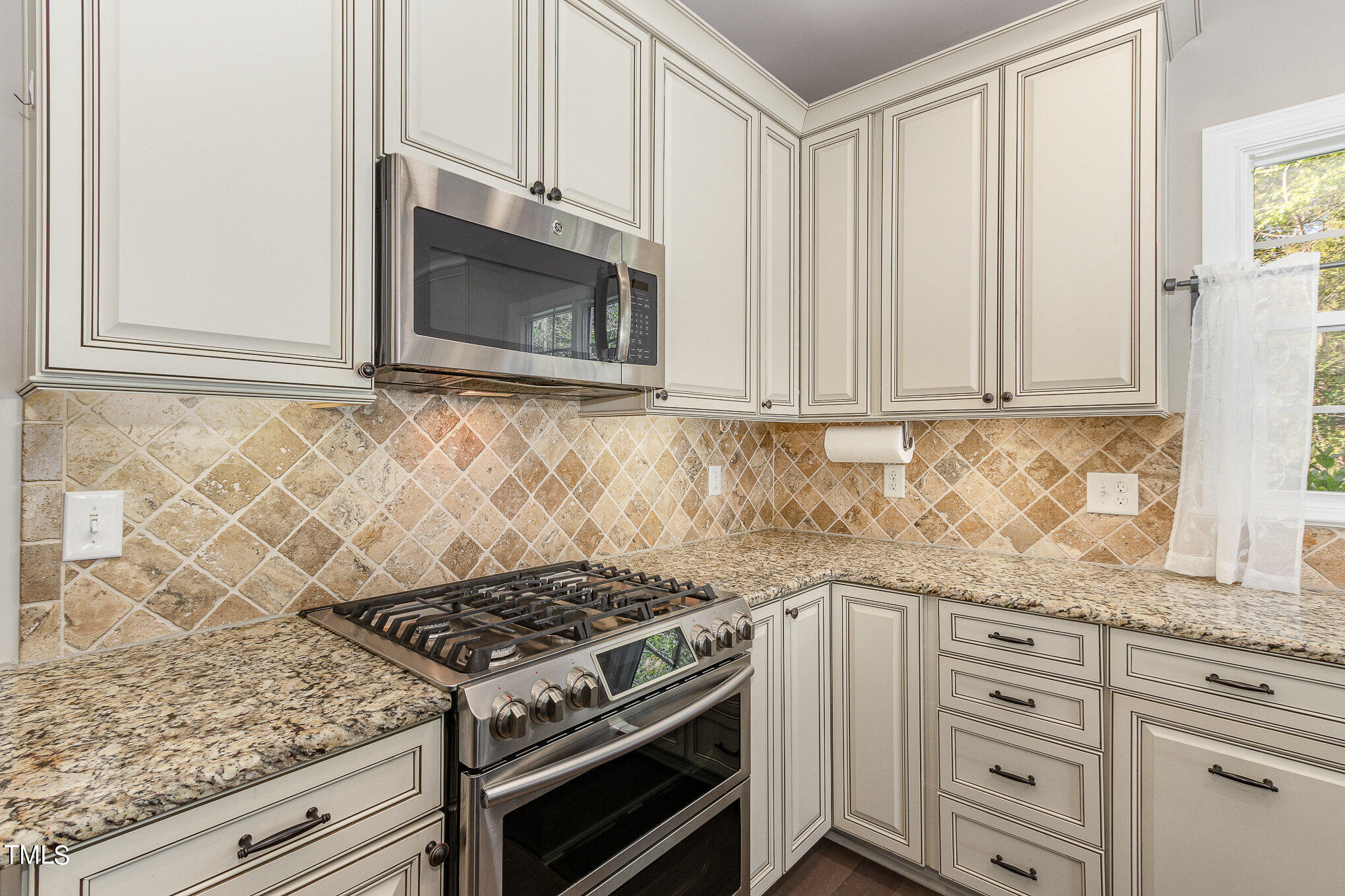 3640 Pineview Circle Durham, NC 27705 - Photo 13 of 41 a kitchen with granite countertop white cabinets and stainless steel appliances