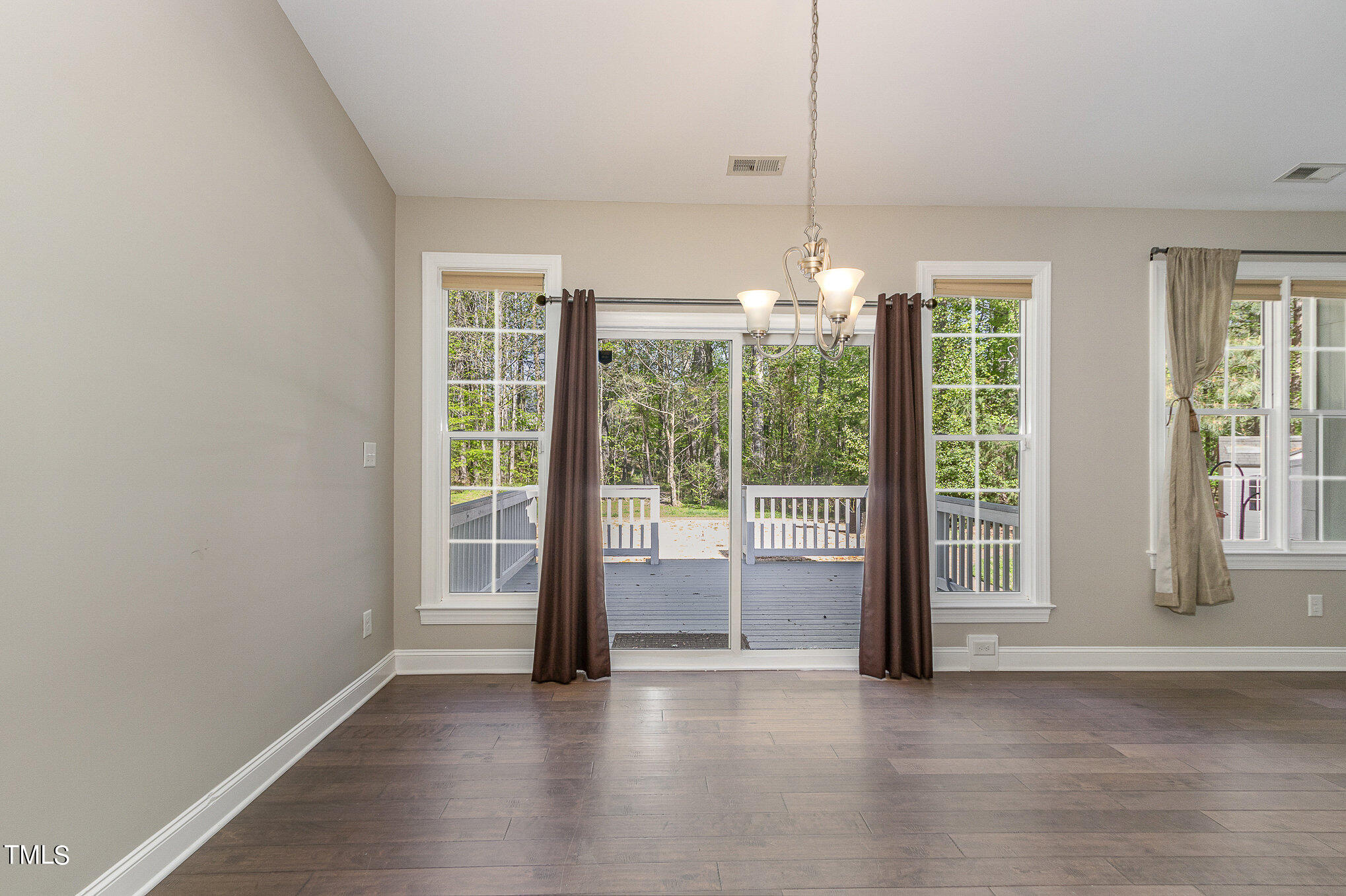3640 Pineview Circle Durham, NC 27705 - Photo 16 of 41 a view of an empty room with wooden floor and a window