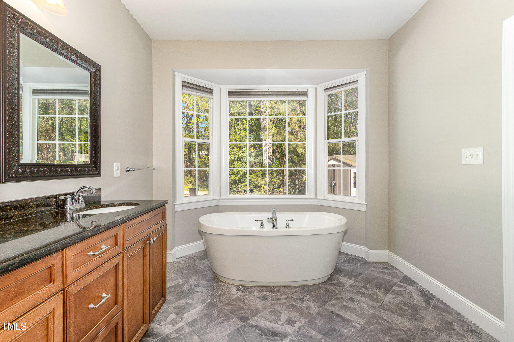 3640 Pineview Circle Durham, NC 27705 - Photo 27 of 41 a spacious bathroom with a bathtub double sink and mirror