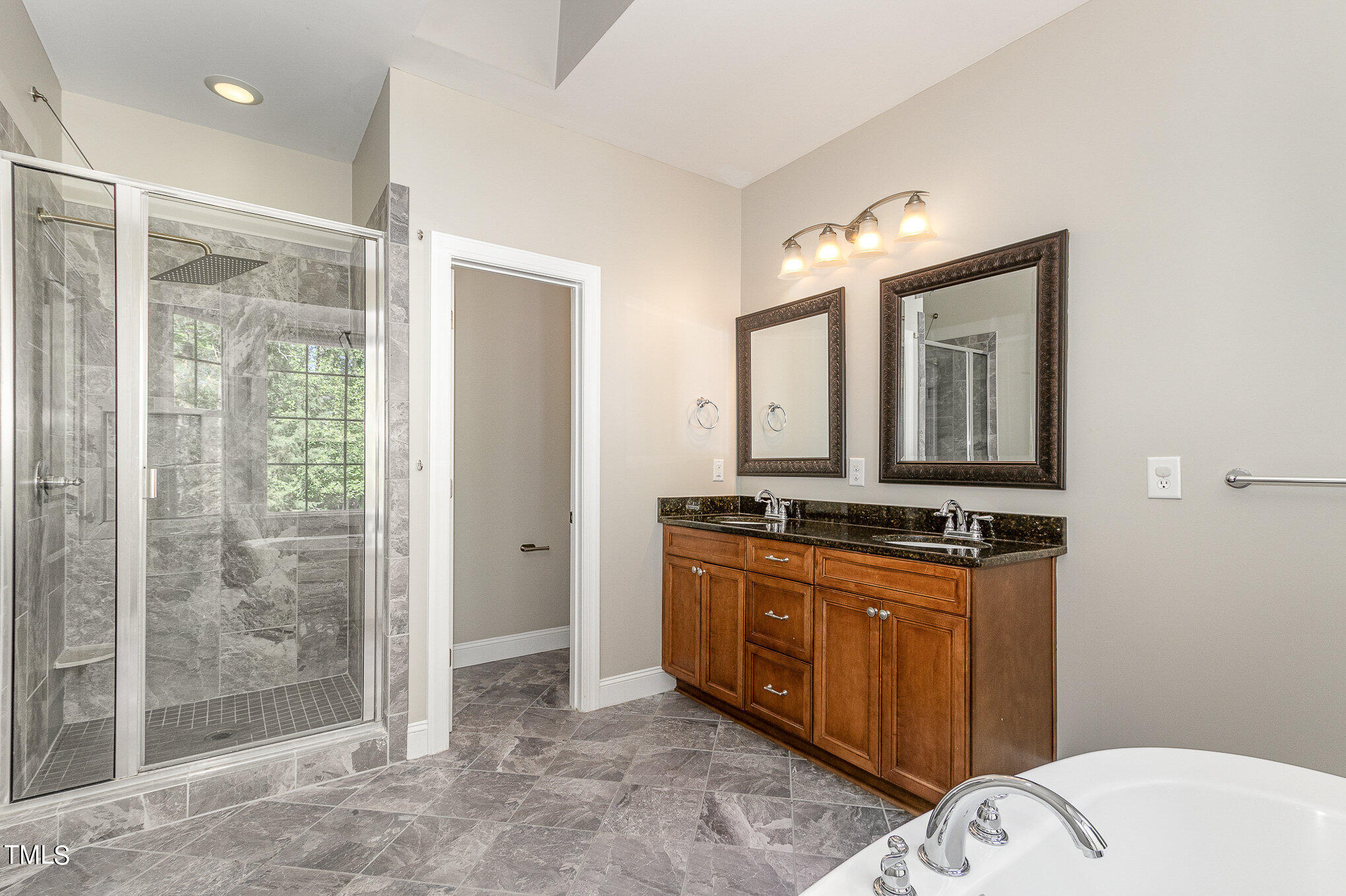 3640 Pineview Circle Durham, NC 27705 - Photo 29 of 41 a bathroom with a granite countertop sink a mirror and a shower