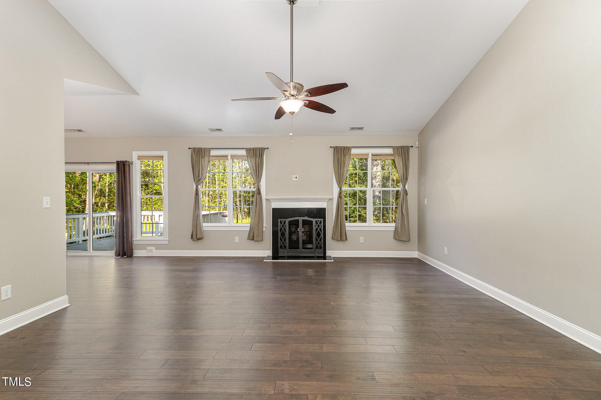 3640 Pineview Circle Durham, NC 27705 - Photo 6 of 41 a view of an empty room with wooden floor fireplace and a window