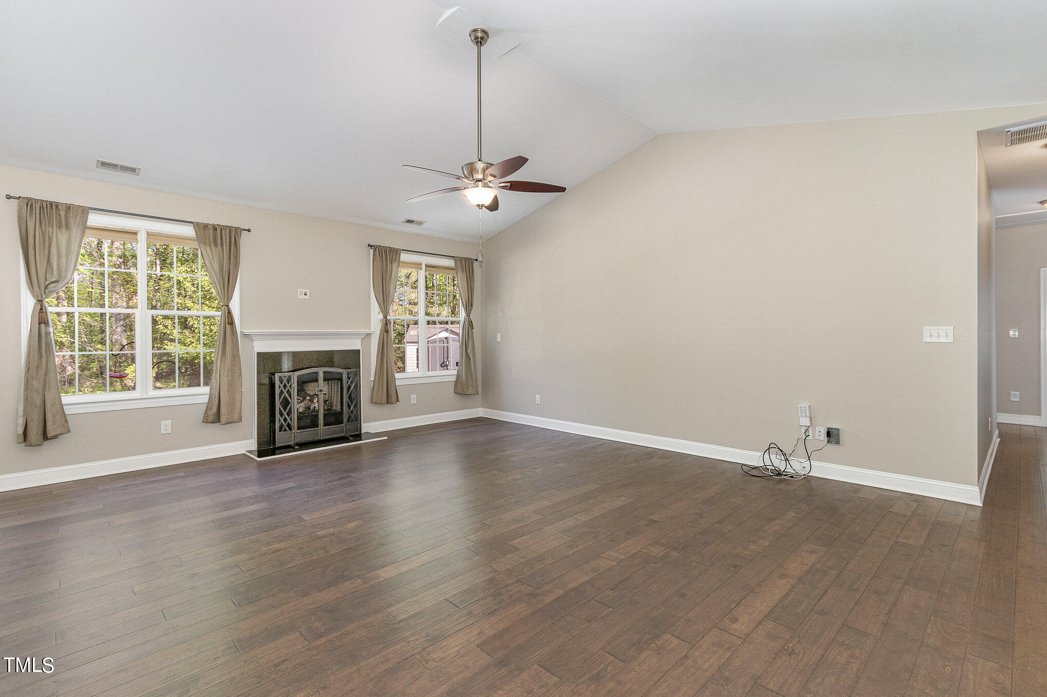 3640 Pineview Circle Durham, NC 27705 - Photo 8 of 41 an empty room with windows fireplace and wooden floor