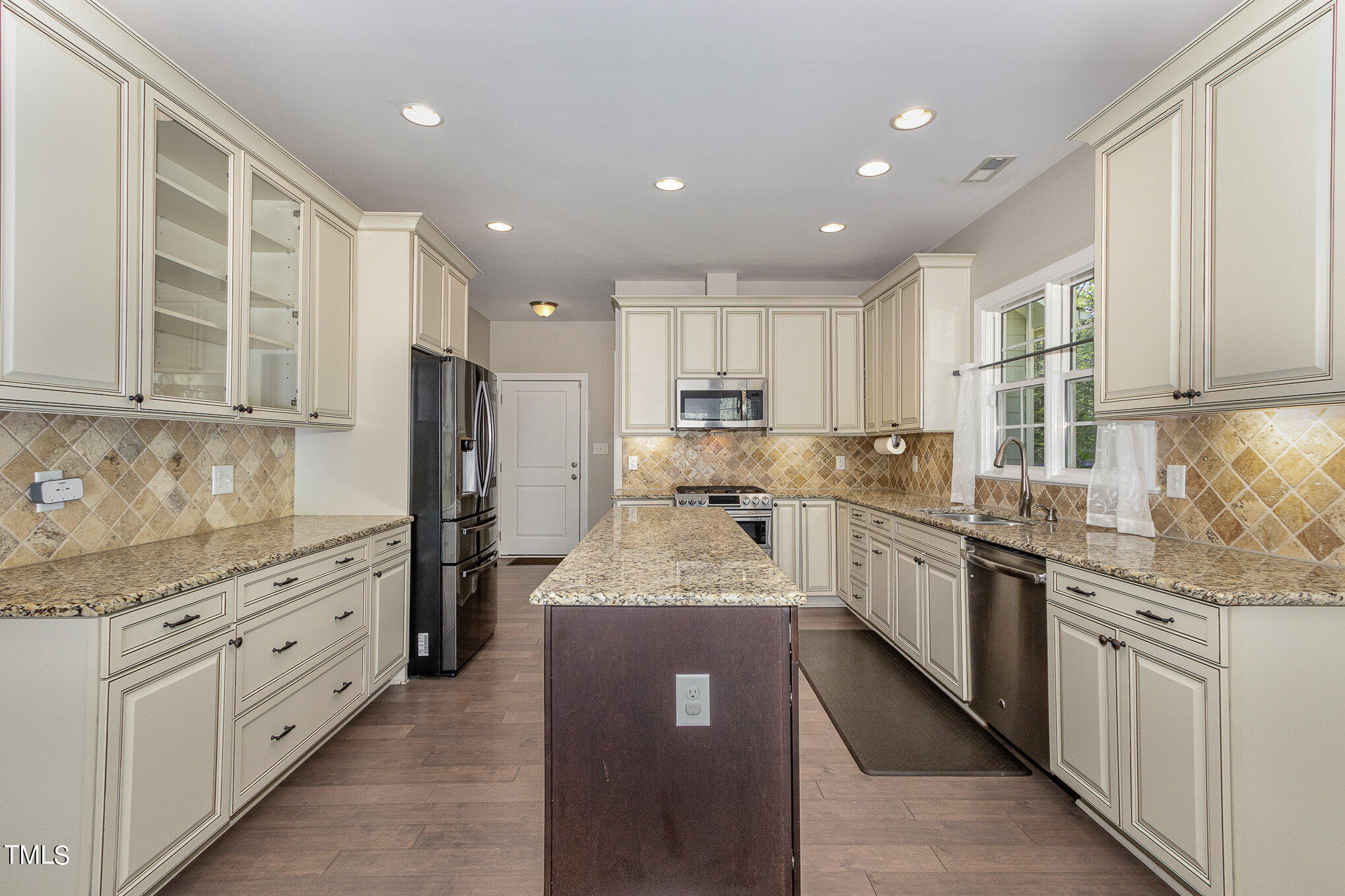 3640 Pineview Circle Durham, NC 27705 - Photo 9 of 41 a large kitchen with stainless steel appliances granite countertop a sink counter space cabinets and a large window