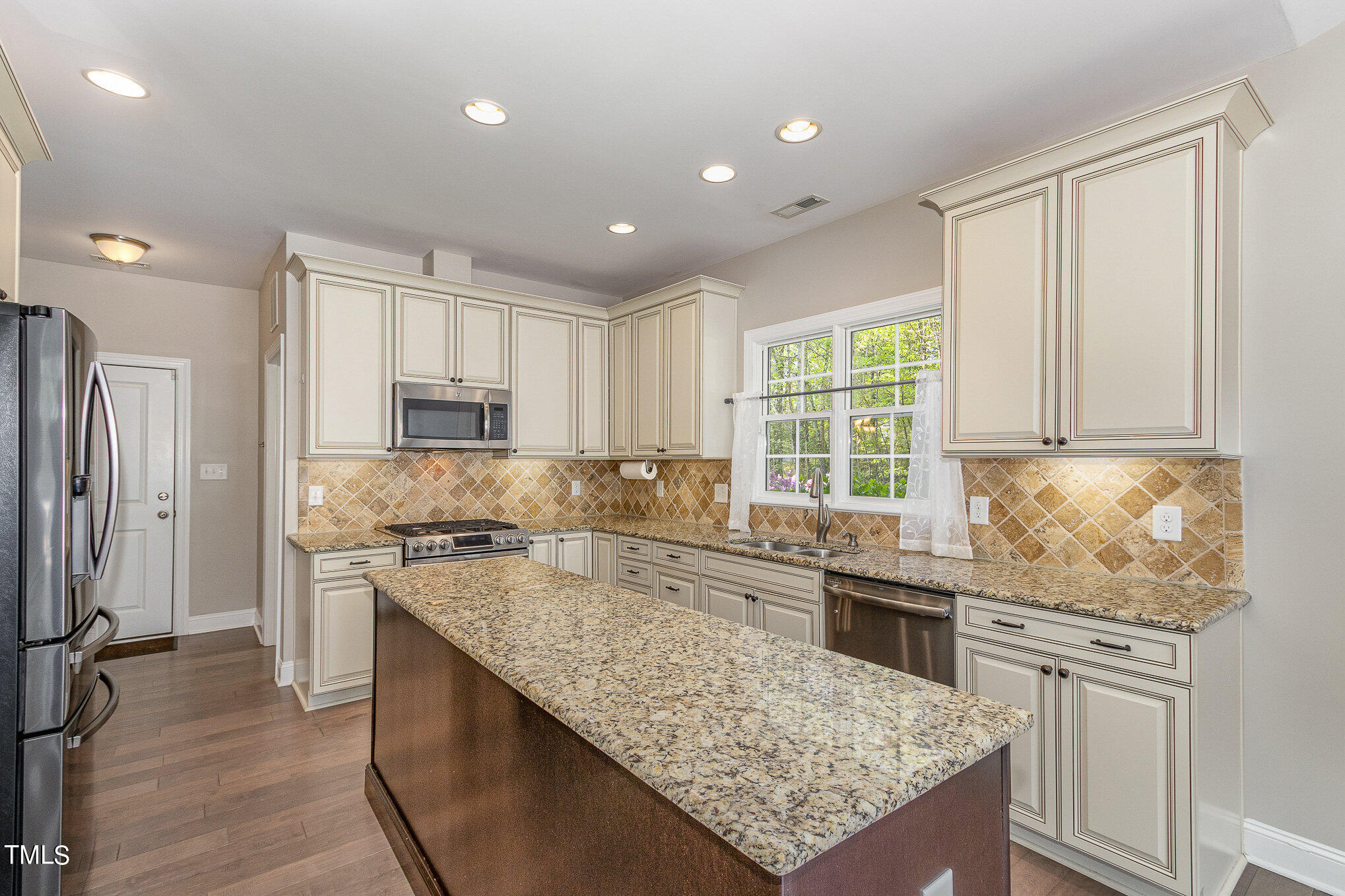 3640 Pineview Circle Durham, NC 27705 - Photo 10 of 41 a kitchen with stainless steel appliances granite countertop a sink stove and refrigerator