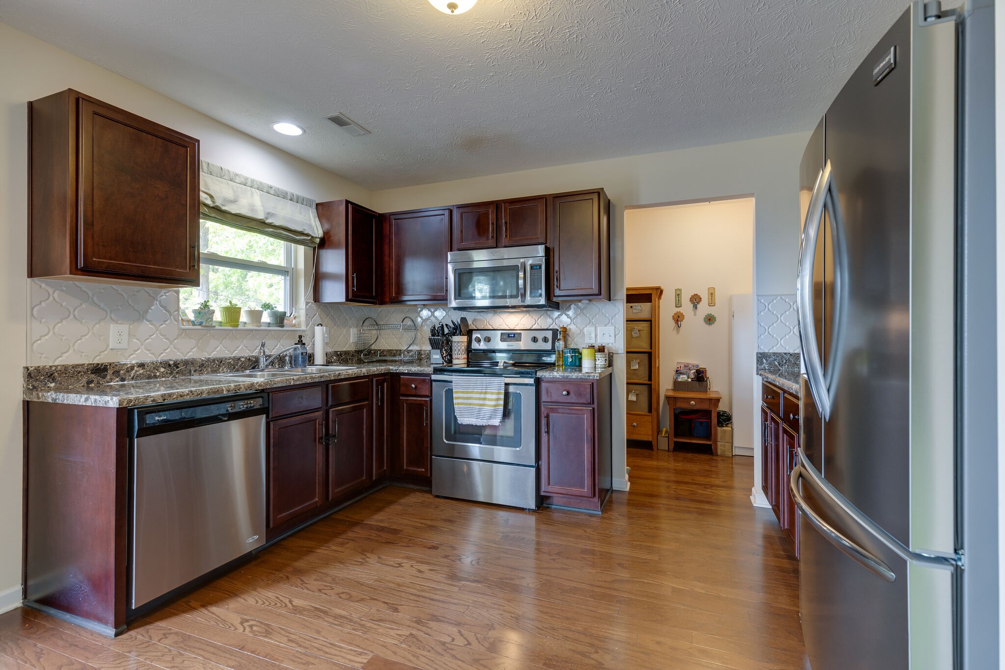 4757 Backstretch Boulevard Antioch, TN 37013 - Photo 14 of 39 a kitchen with stainless steel appliances granite countertop a refrigerator stove and sink
