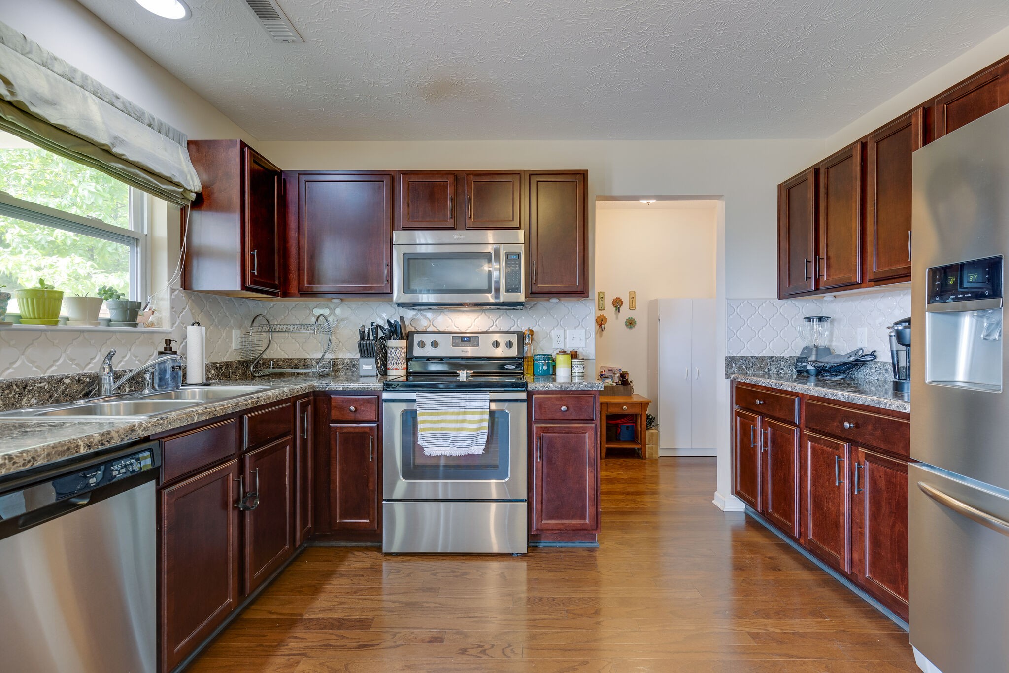 4757 Backstretch Boulevard Antioch, TN 37013 - Photo 15 of 39 a kitchen with stainless steel appliances granite countertop a stove a sink dishwasher a refrigerator and a microwave oven