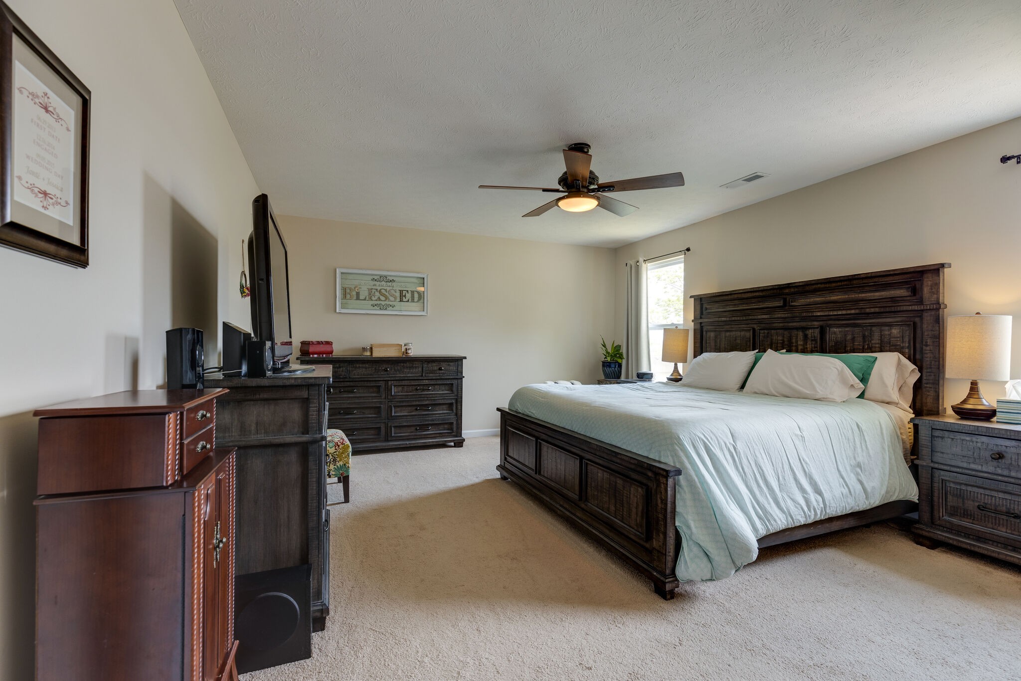 4757 Backstretch Boulevard Antioch, TN 37013 - Photo 26 of 39 a bedroom with a bed dresser and a flat tv screen