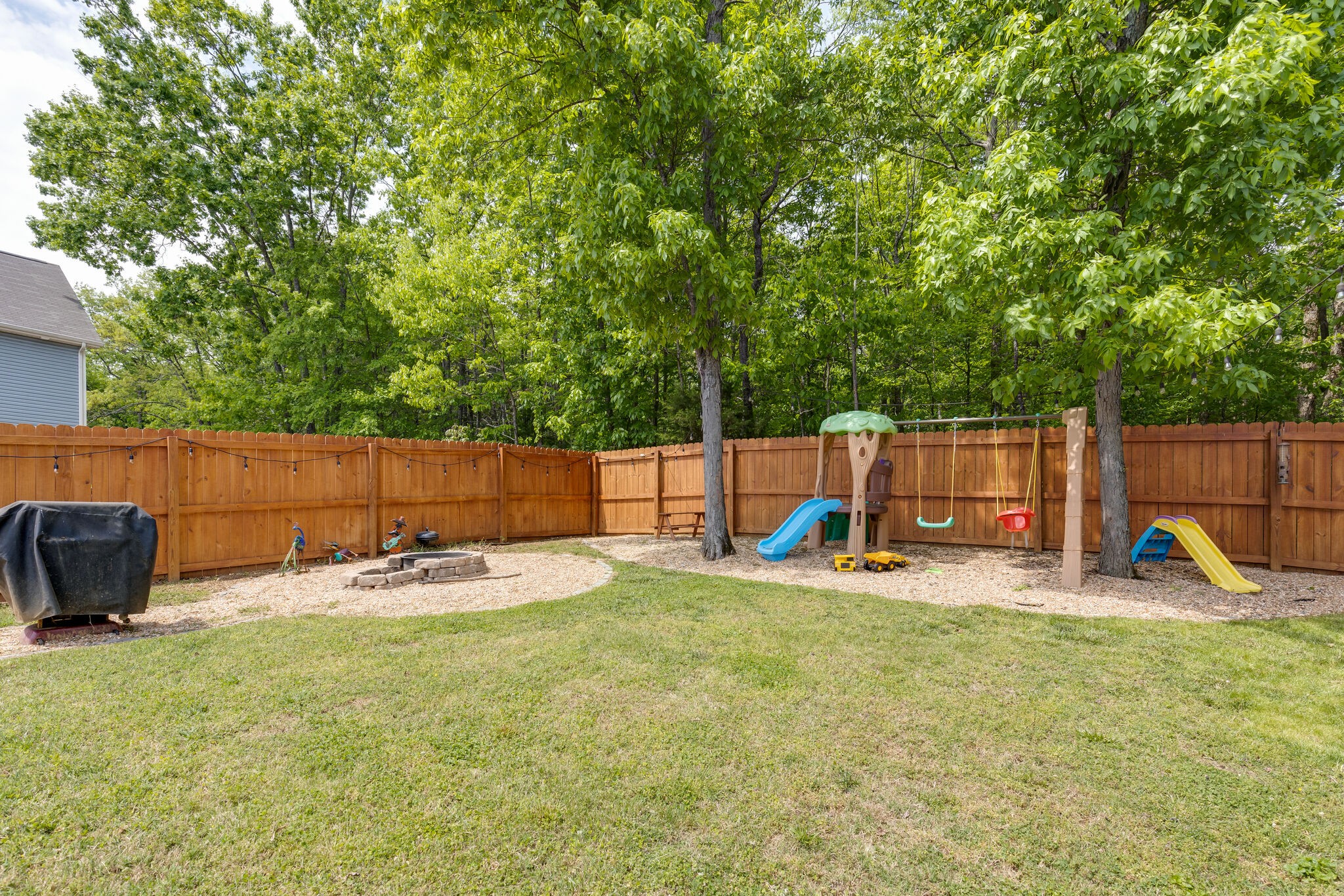 4757 Backstretch Boulevard Antioch, TN 37013 - Photo 38 of 39 a view of a backyard with chairs and a slide