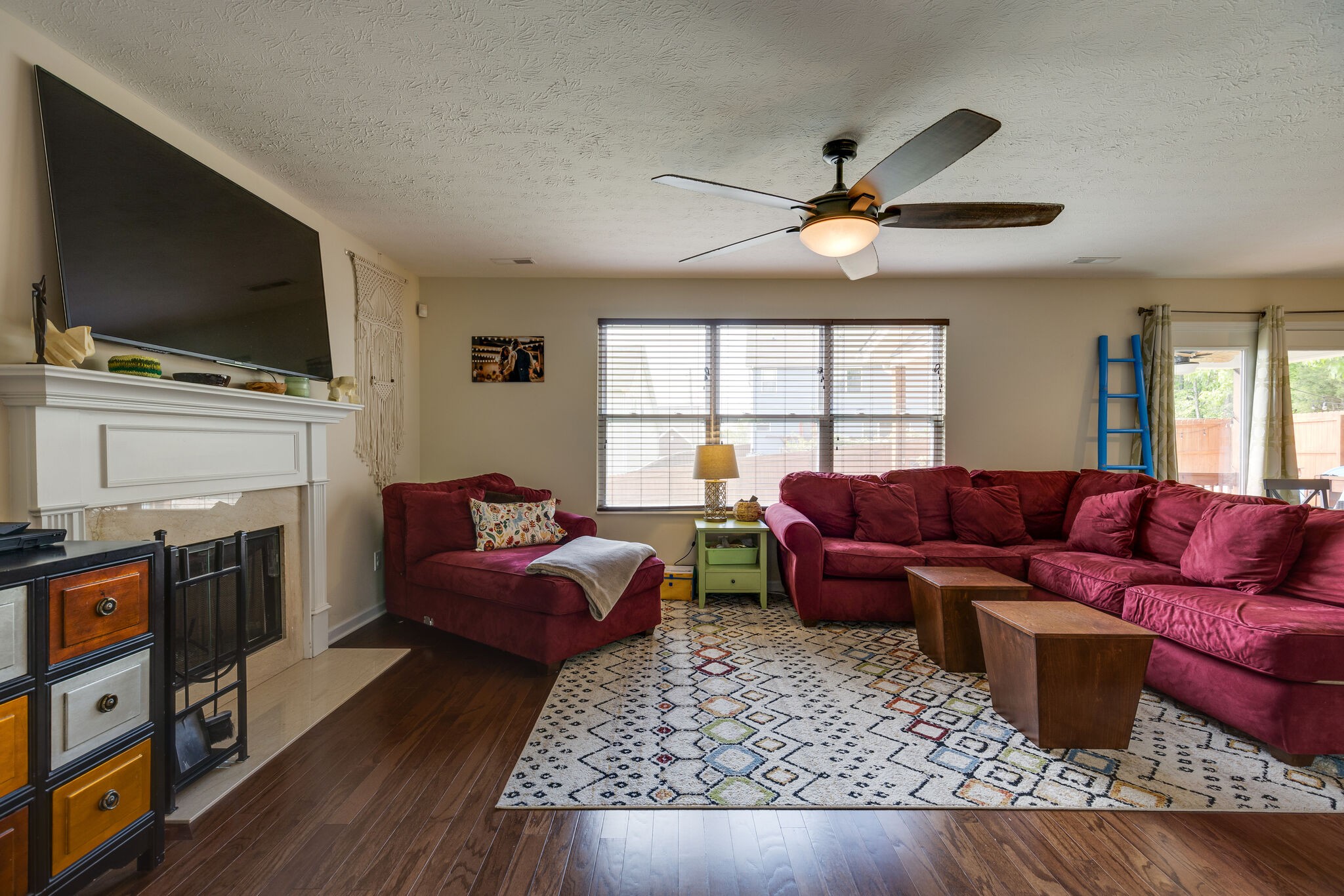 4757 Backstretch Boulevard Antioch, TN 37013 - Photo 10 of 39 a living room with furniture a flat screen tv and a fireplace
