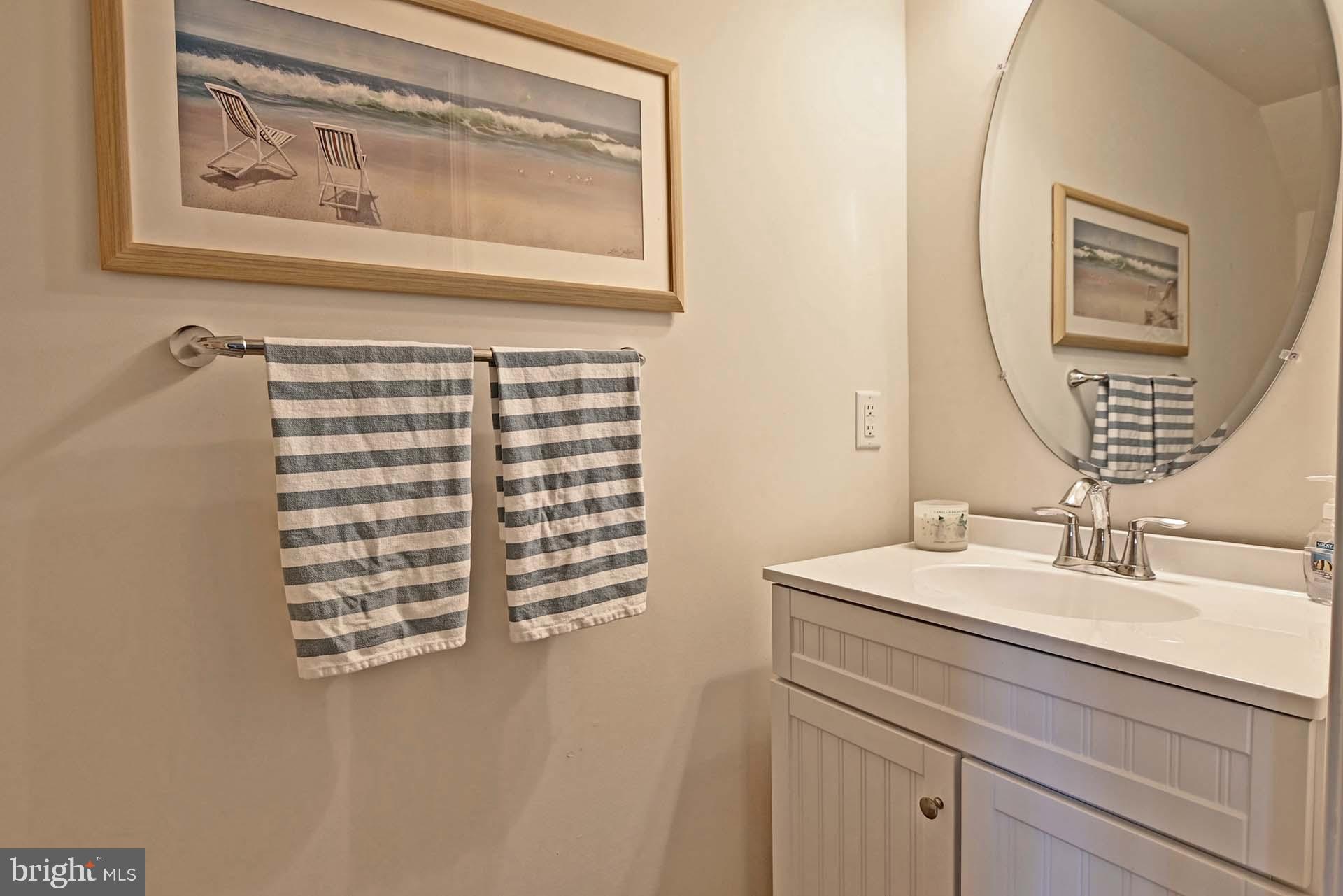 6 Basin Cove Way Ocean View, DE 19970 - Photo 14 of 45 a bathroom with a sink a vanity and a mirror