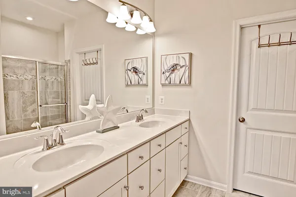 a bathroom with double vanity sink a mirror and vanity