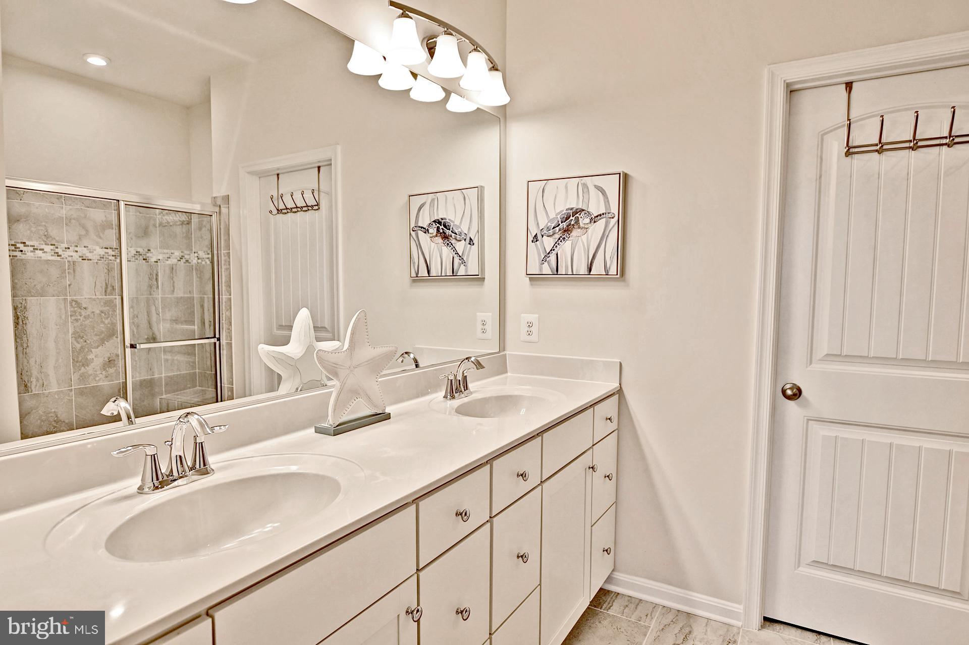 6 Basin Cove Way Ocean View, DE 19970 - Photo 18 of 45 a bathroom with double vanity sink a mirror and vanity
