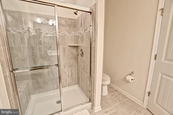 a bathroom with a glass shower door