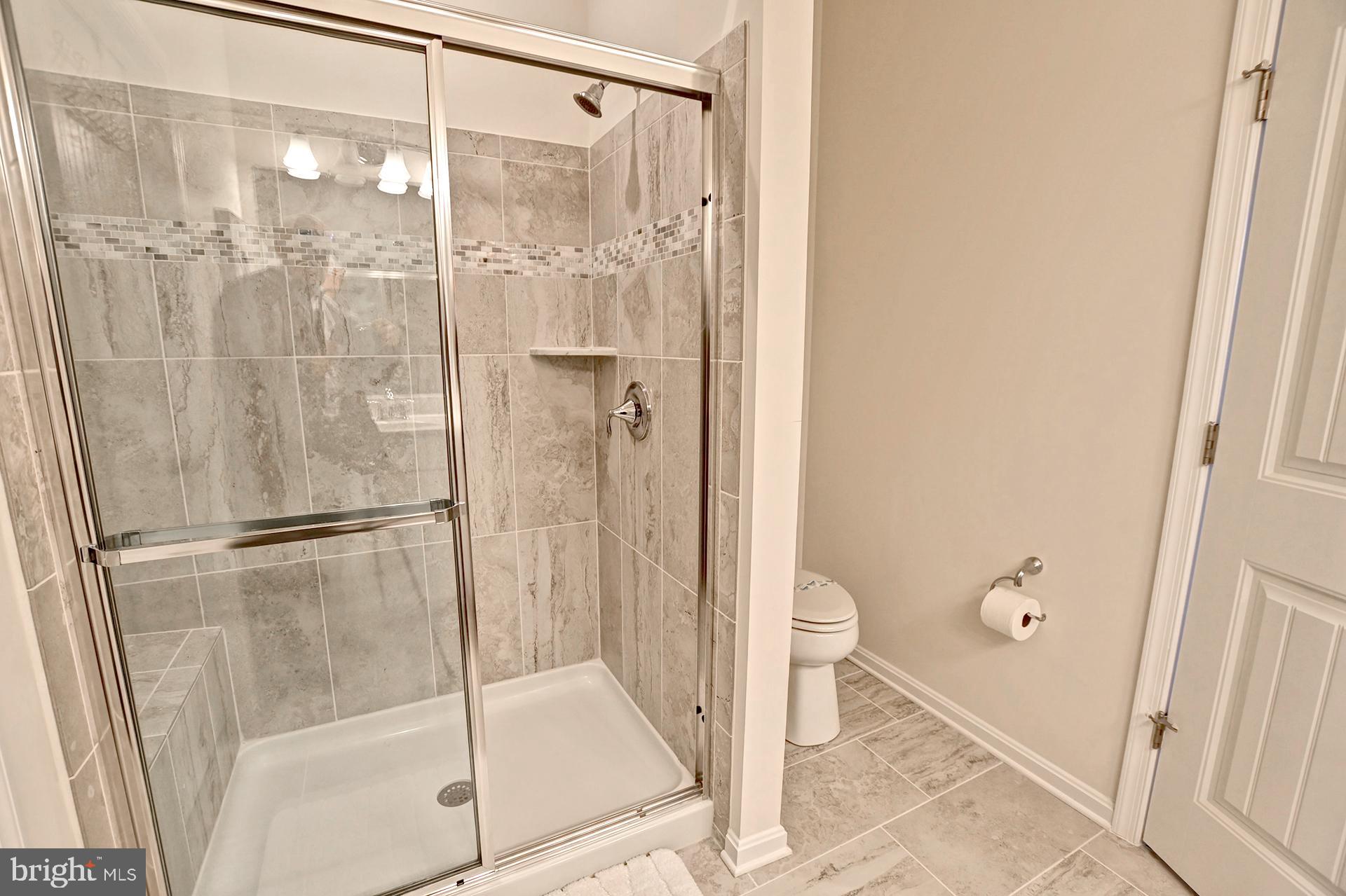 6 Basin Cove Way Ocean View, DE 19970 - Photo 19 of 45 a bathroom with a glass shower door