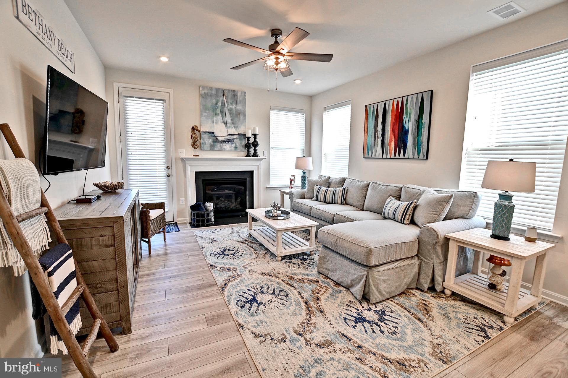 6 Basin Cove Way Ocean View, DE 19970 - Photo 2 of 45 a living room with furniture a flat screen tv and a fireplace