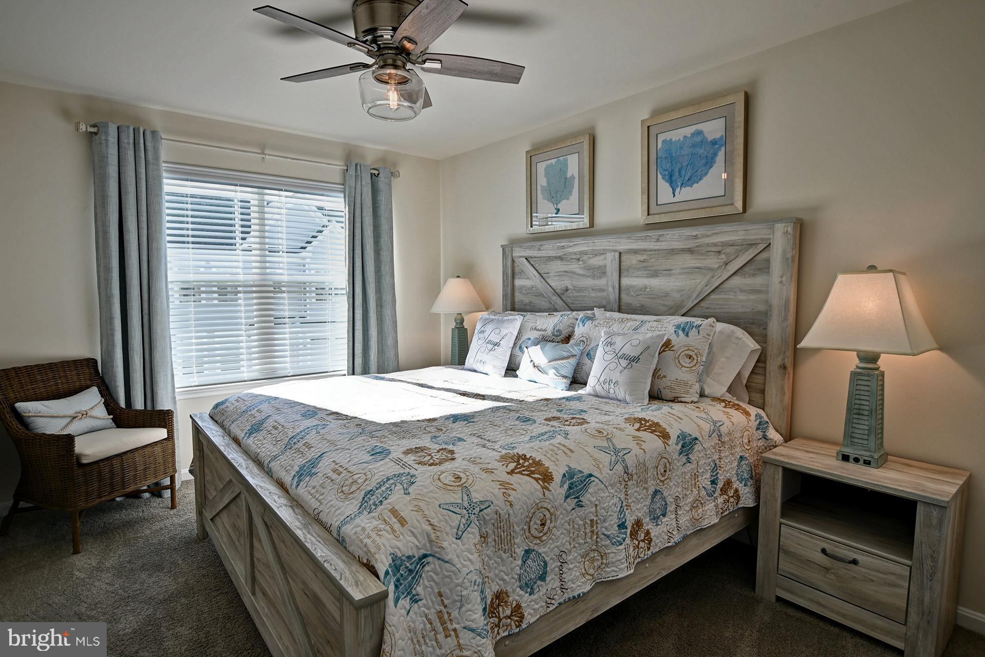 6 Basin Cove Way Ocean View, DE 19970 - Photo 24 of 45 a bedroom with a bed and a chandelier