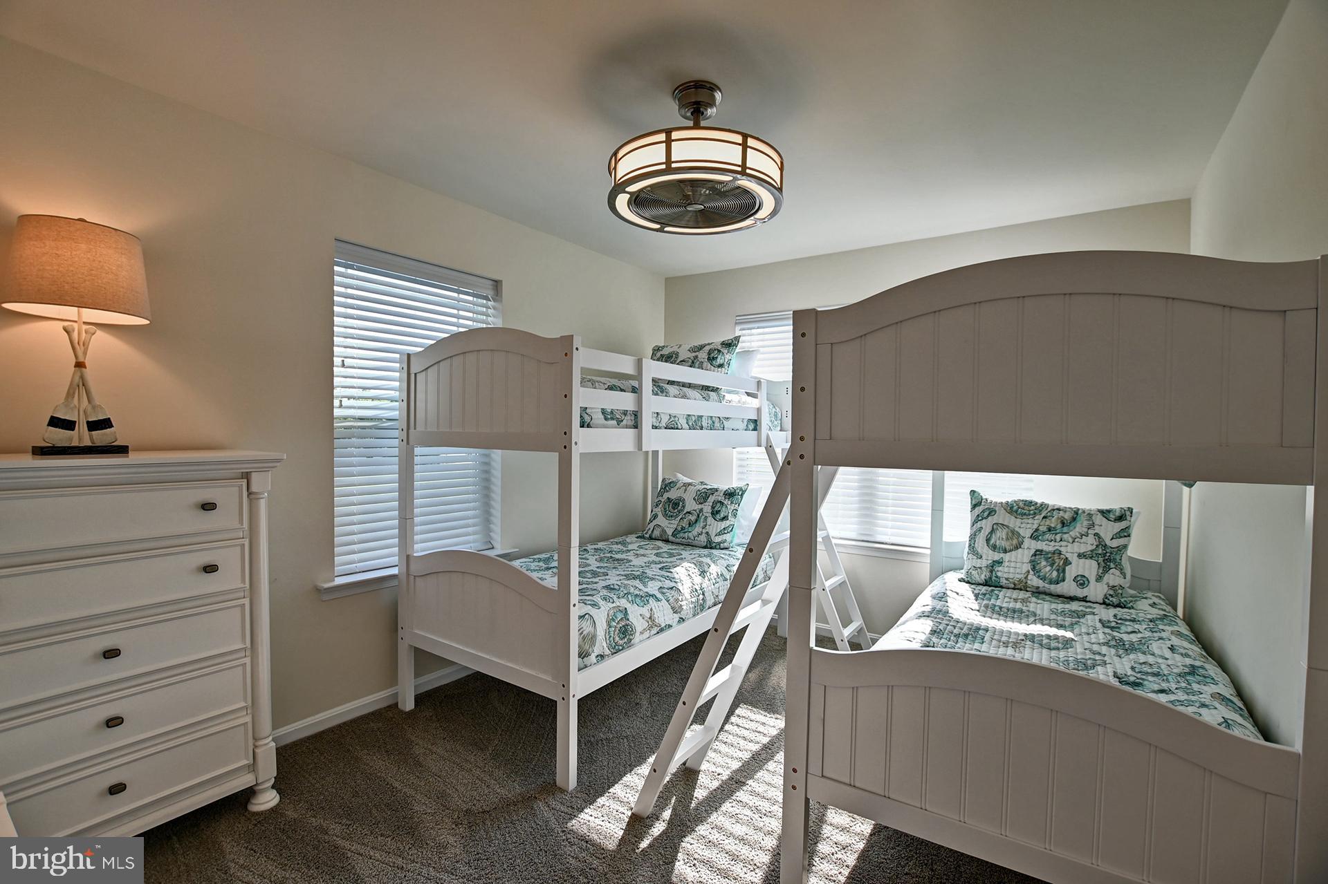 6 Basin Cove Way Ocean View, DE 19970 - Photo 26 of 45 a bedroom with a bed and a chandelier
