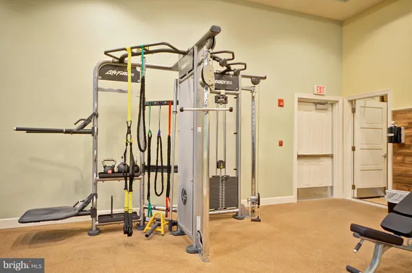 a room with gym equipment and a large window