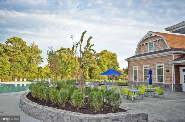 a view of a swimming pool and outdoor seating