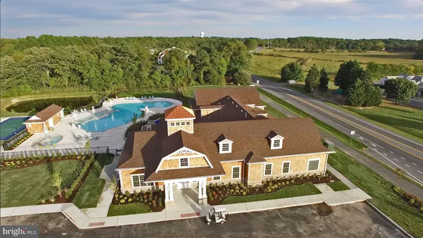 an aerial view of houses with a lake