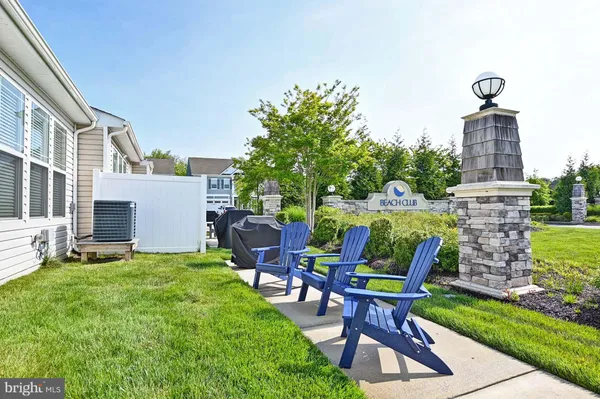 a view of a chairs and table in backyard of the house