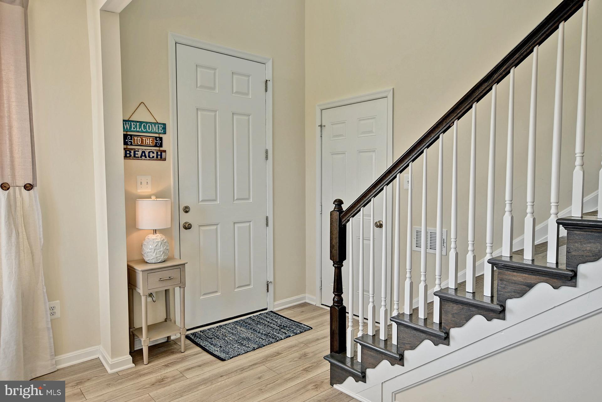 6 Basin Cove Way Ocean View, DE 19970 - Photo 8 of 45 a view of a hallway with wooden floor and staircase